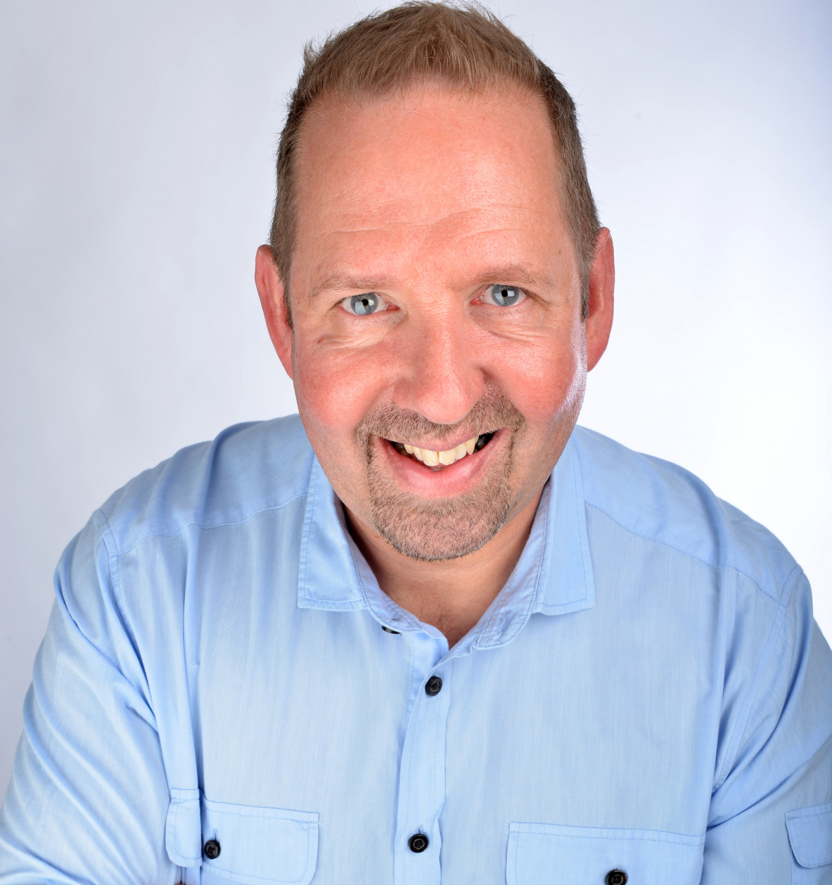 Alfie Moore headshot (blue shirt) photo by Steve Ullathorne